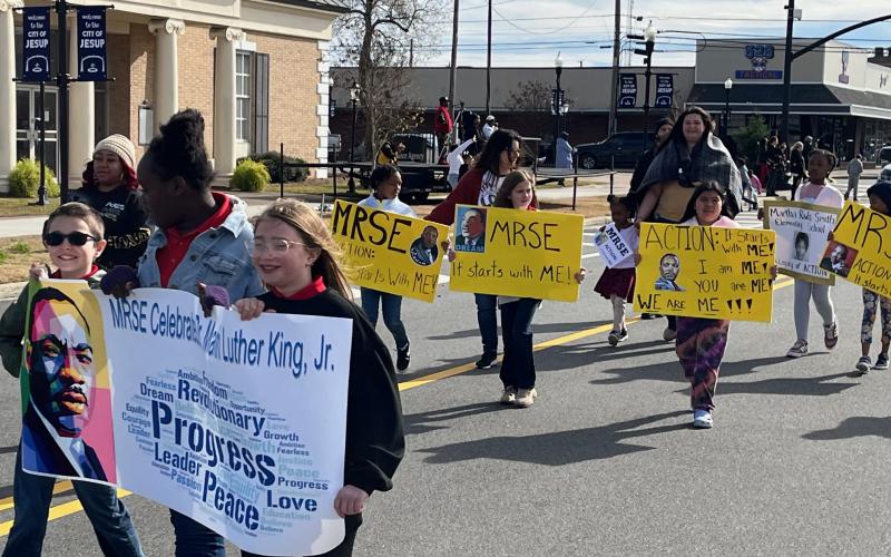 A downtown Jesup parade highlighted a full slate of weekend events celebrating Martin Luther King Jr.’s legacy. Above, students of Martha Rawls Smith Elementary proclaim the theme of the weekend, “Action: It starts with ME!”