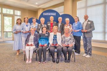 The 1976 Berry College women’s basketball team receives awards honoring the 50th anniversary of their national title and their induction into the Berry College Hall of Fame.  Wayne County’s Barbara Struckhoff, front row, far right, was one of the players honored. 