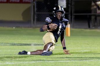 TREY GILLEY / Staff P.J. Brown slides down after intercepting a pass at the goal line to secure the 24-21 win against Liberty County High.  