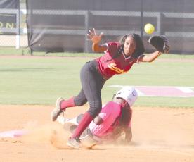 ERIC DENTY / Staff Pinch runner Bella Ellis slides hard into second base in play against Maynard Jackson High of Atlanta. The Lady Jacket team and fans wore pink in honor of Breast Cancer Awareness Month