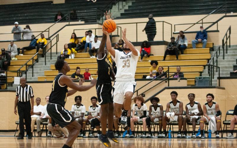 Jacket Steve Pena drives to the basket against Groves High.