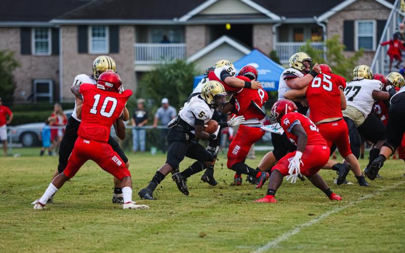 Jah Ross had a number of explosive runs against Glynn Academy in Friday’s scrimmage. He gets help from blockers Miles Starling, No. 54; Jake Trebil, No. 75; and Jose Valdez, No. 77.       .