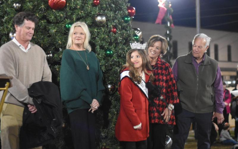 Ceremonial tree lighter Emi Peel, center, stands with members of the Bland family: from left, David and Arria Bland and Joy and Lex Kenerly.