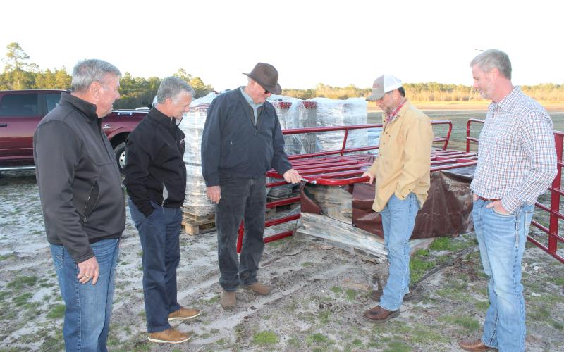 Checking out fencing material for the new county agricultural complex are, from left, Wayne County Board of Commissioners Chair Mike Gordon, County Administrator Paul Drawdy, project manager Randy Franks, Extension coordinator Mark Frye and Justin Purcell of Circle W. According to Franks, the fencing will protect both children and livestock.