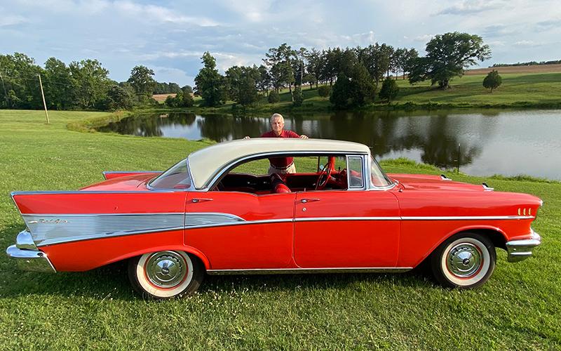 Gary Hill stands behind the 1957 Chevrolet that was given to him by his son, Alex. When Gary was a student at UGA in the 1960s, he drove a 1957 Chevy convertible, red with a black top. (Photo by Dink NeSmith)
