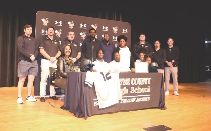 ERIC DENTY / Staff Jacket baseball player Isaiah Lee signed last week to play baseball at Andrews College in Cuthbert. He is joined by his parents, Renee Lee and Reginald Lee; his family; and the WCHS baseball coaching staff.