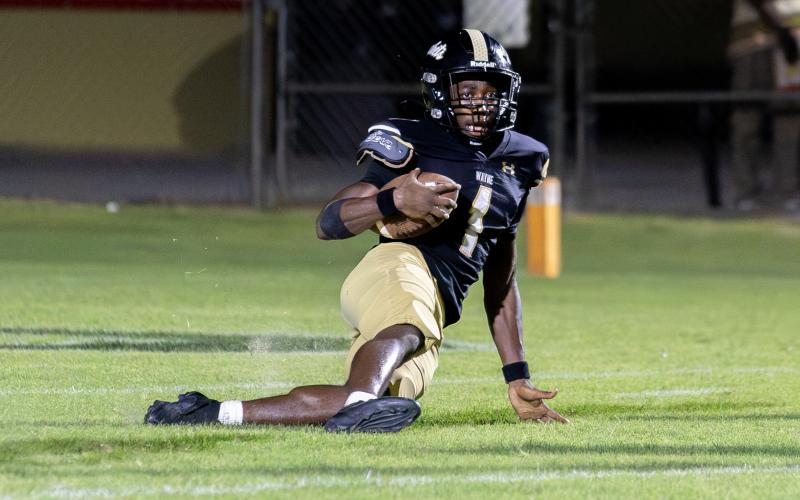 TREY GILLEY / Staff P.J. Brown slides down after intercepting a pass at the goal line to secure the 24-21 win against Liberty County High.