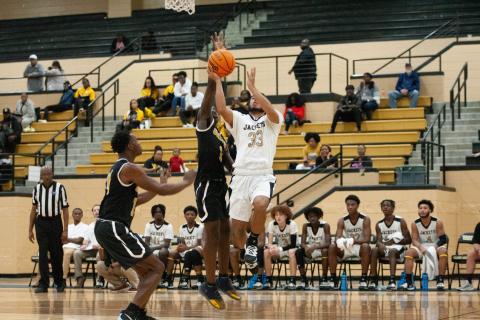 Jacket Steve Pena drives to the basket against Groves High. 
