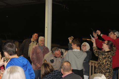 Steven Crane of the Wayne County Sheriff’s Office puckers up to kiss a pig. 