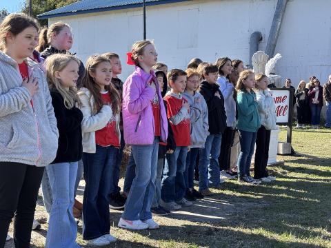 The students of the Screven Elementary Chorus sing the National Anthem during the ceremony dedicating the new Veterans Garden and proclaiming the Year of the Youth in Screven.
