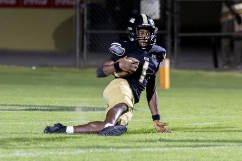 TREY GILLEY / Staff P.J. Brown slides down after intercepting a pass at the goal line to secure the 24-21 win against Liberty County High.  