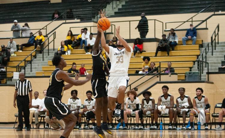 Jacket Steve Pena drives to the basket against Groves High.