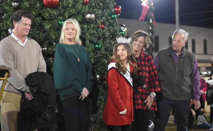 Ceremonial tree lighter Emi Peel, center, stands with members of the Bland family: from left, David and Arria Bland and Joy and Lex Kenerly.