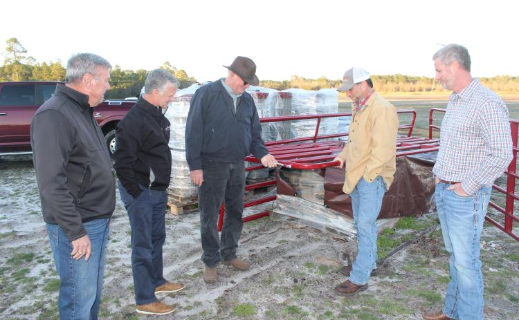 Checking out fencing material for the new county agricultural complex are, from left, Wayne County Board of Commissioners Chair Mike Gordon, County Administrator Paul Drawdy, project manager Randy Franks, Extension coordinator Mark Frye and Justin Purcell of Circle W. According to Franks, the fencing will protect both children and livestock.