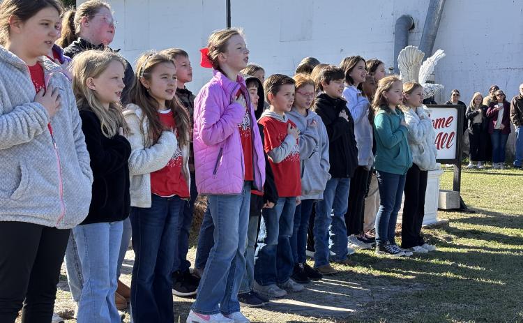 The students of the Screven Elementary Chorus sing the National Anthem during the ceremony dedicating the new Veterans Garden and proclaiming the Year of the Youth in Screven.