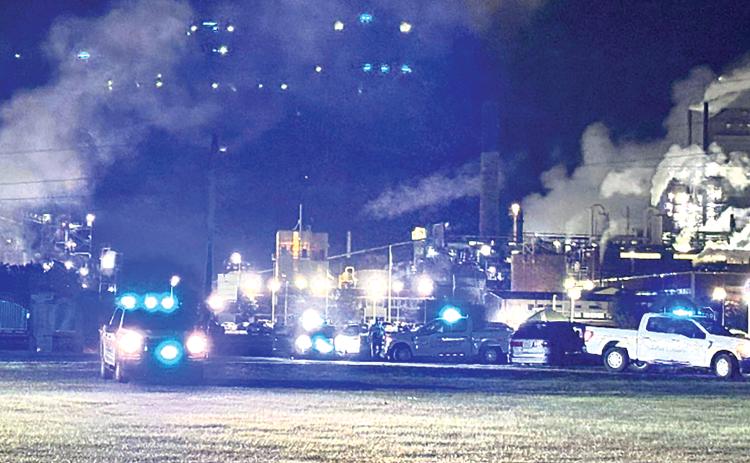 Flashing lights on law-enforcement vehicles compete with the lights from the RYAM plant following an incident of shots fired at the U.S. Hwy. 301 intersection with Jaycee Landing Road. No one was reported as injured in the incident, and investigation identified a suspect in the event.
