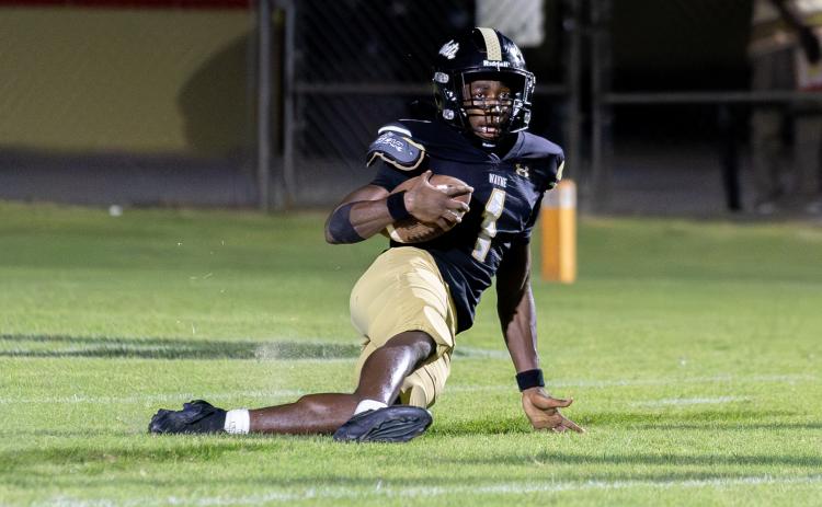 TREY GILLEY / Staff P.J. Brown slides down after intercepting a pass at the goal line to secure the 24-21 win against Liberty County High.