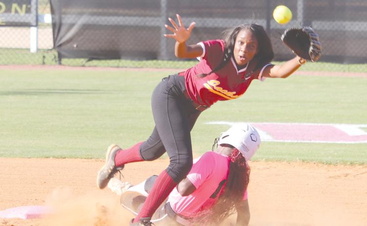 ERIC DENTY / Staff Pinch runner Bella Ellis slides hard into second base in play against Maynard Jackson High of Atlanta. The Lady Jacket team and fans wore pink in honor of Breast Cancer Awareness Month