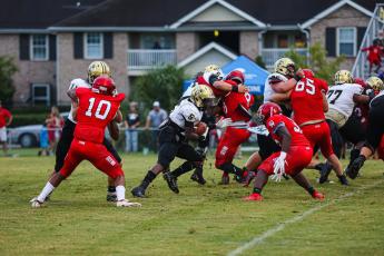 Jah Ross had a number of explosive runs against Glynn Academy in Friday’s scrimmage. He gets help from blockers Miles Starling, No. 54; Jake Trebil, No. 75; and Jose Valdez, No. 77.       .