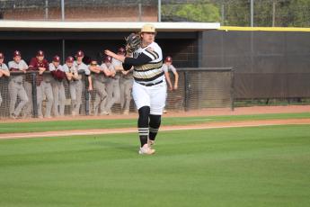 Jacket senior pitcher Gavin Mixon fields a bunt in play against Benedictine. He pitched a three-hit win in game one. 