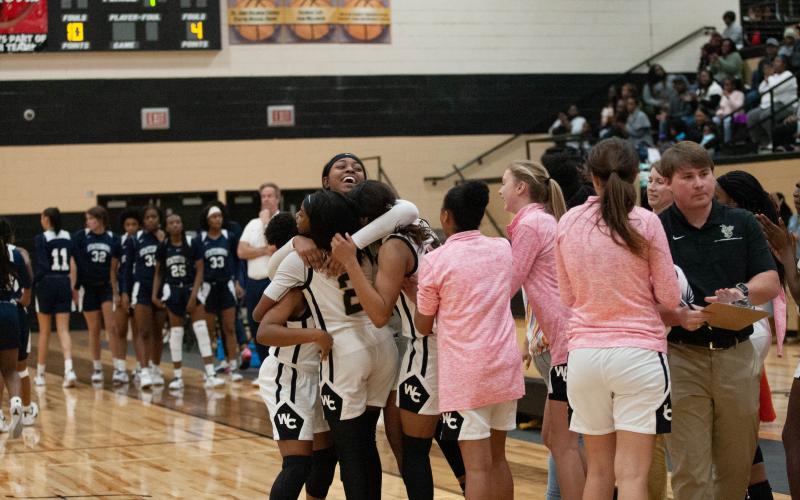 The Lady Jackets celebrate after a hard-fought win over Statesboro High.