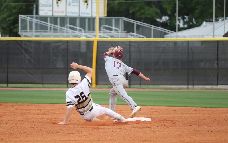 Yellow Jacket left fielder Garrison Grantham breaks up a double-play attempt by the BC Cadets.  